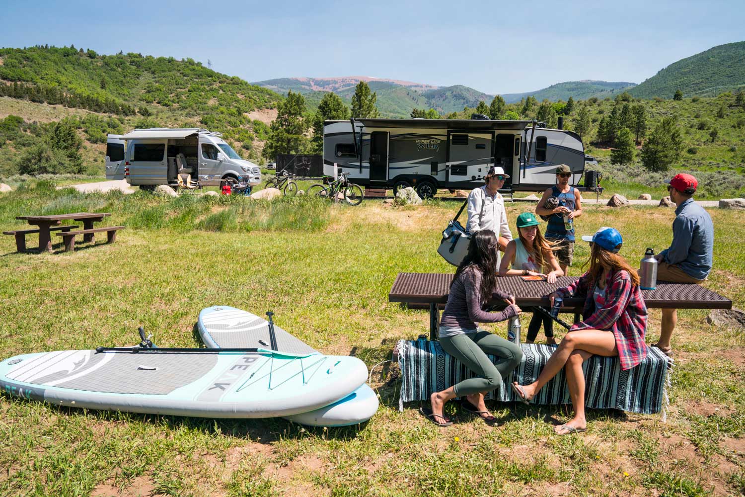 Family relaxing at table while RV boondocking